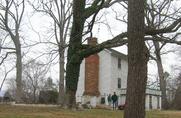 Rear view of the house with a cinder block bathroom attached.